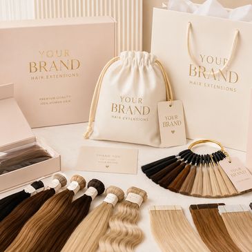 Luxury hair extension packaging and various hair color samples on a neutral background.