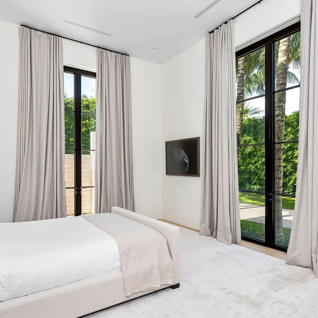Neutral custom drapes framing large windows.