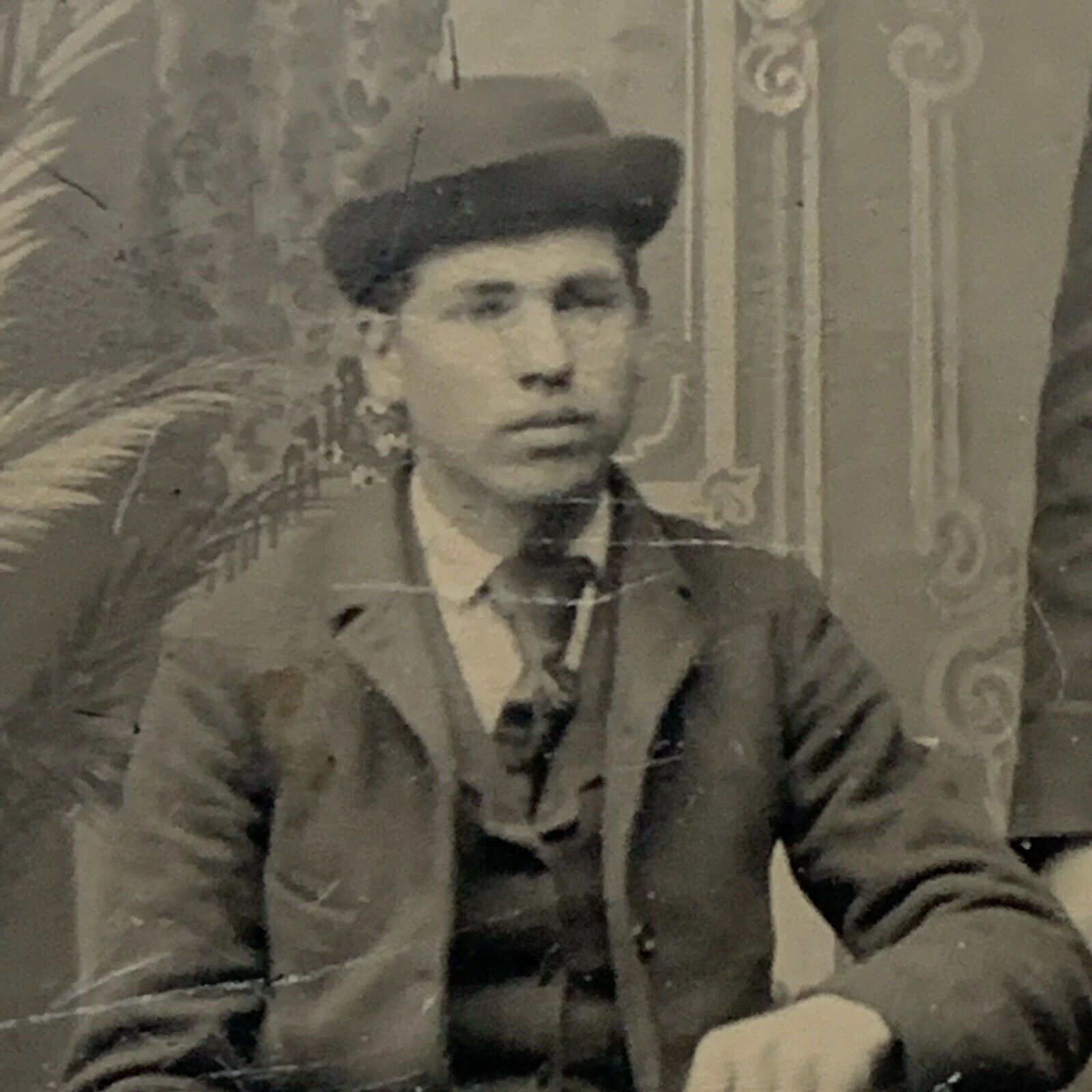 Vintage black-and-white portrait of a man in a suit and hat.
