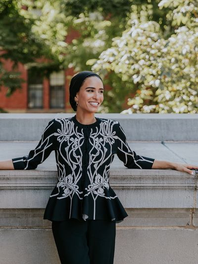 Mafaz Al-Suwaidan looking to the right and smiling by Widener Library on Harvard University campus.