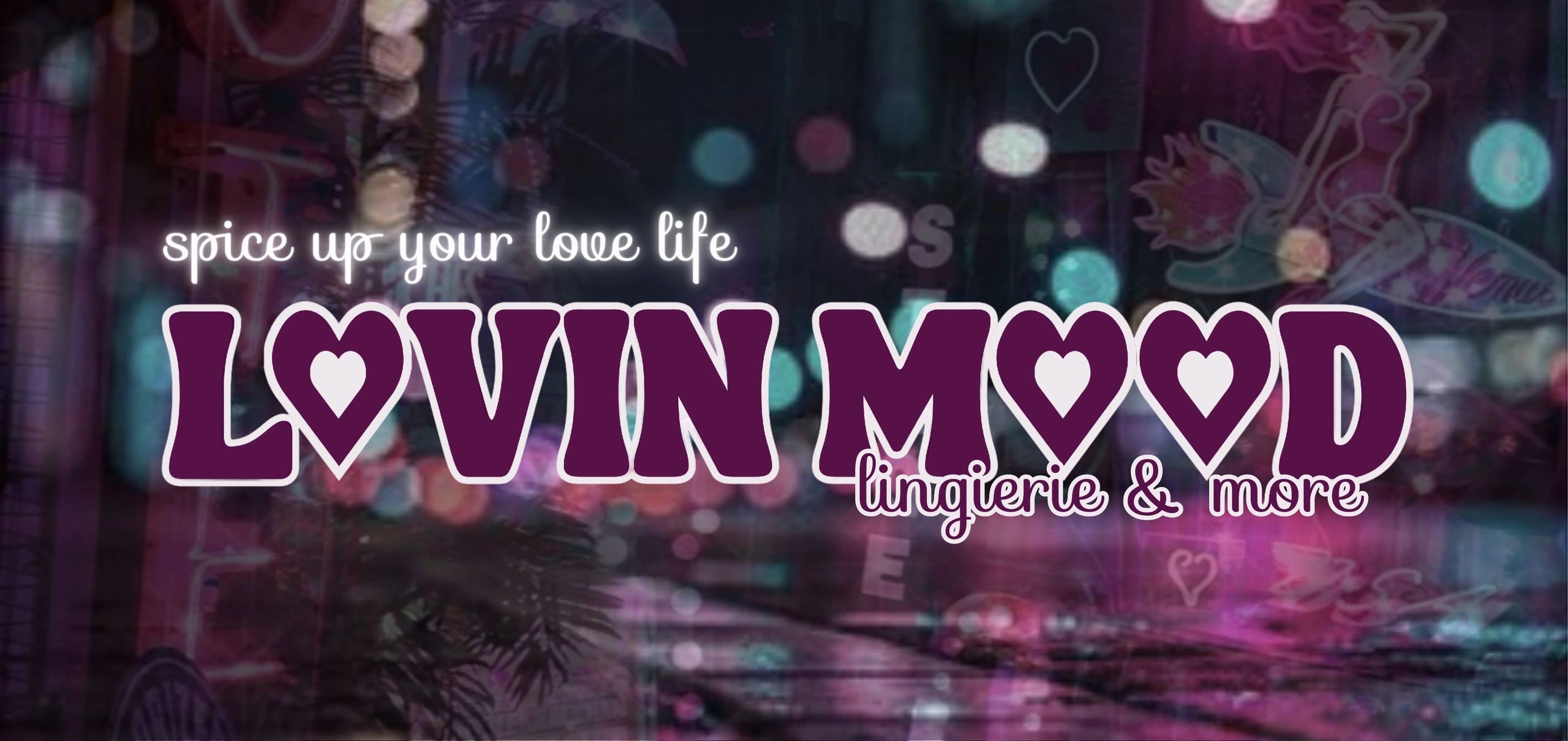 Lovin’ Mood lingerie and more logo on neon city background with text ‘spice up your love life.’
