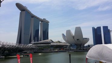 View of Marina Bay Sands and ArtScience Museum in Singapore by the water.