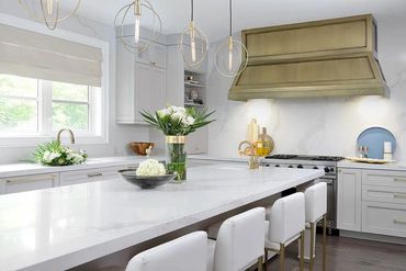 Kitchen renovation with full slab quartz backsplash to match counters!