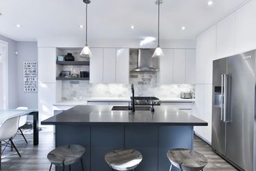 Modern Cabinetry with beautiful stainless steel appliances and quartz counters with stone splash.
