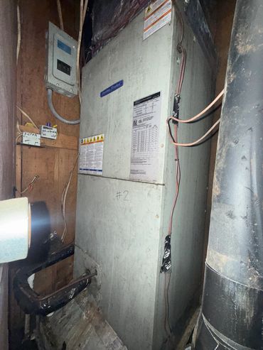 Old HVAC unit in a utility room.