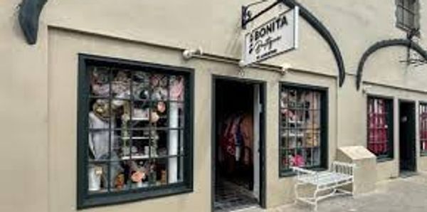 Exterior of La Bonita, a quaint gift and antique shop with display windows.