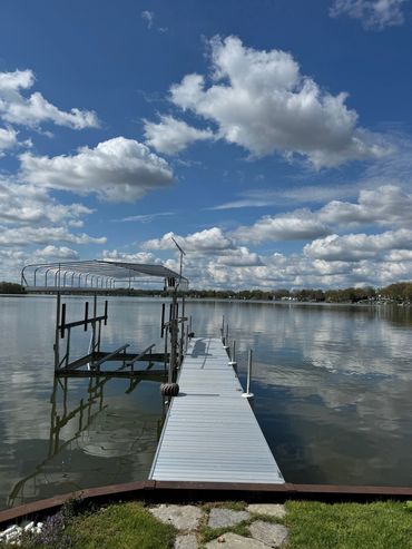 A dock with a pier and a boat in the water.