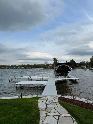 A dock with a boat in it and some water