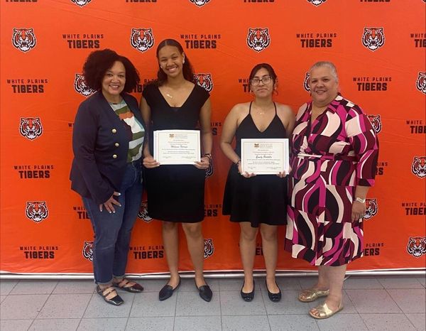 Friends Board Members Meryl Stevens, far left, and Silvia Viciedo, far right, presented certificates
