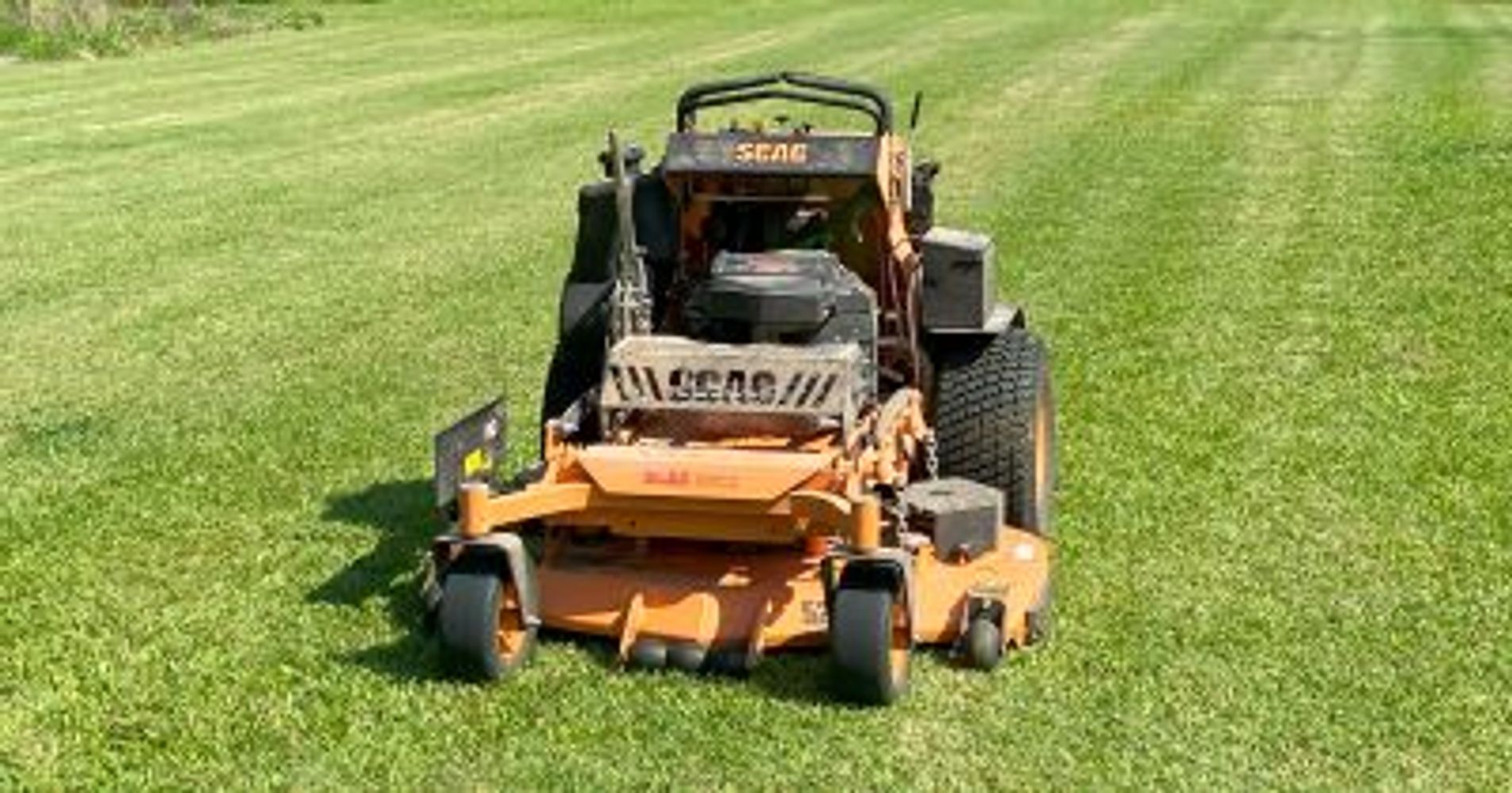 A summer day with grass being freshly cut by Clayton Lawn Care Management with Scag mower in Oxford.