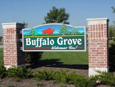 Green Sign-In between Brick Pillars - Buffalo Grove Welcomes you!