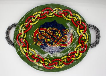 green platter with red and yellow knotwork