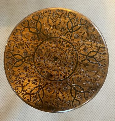 wooden circle with woodburned patterns