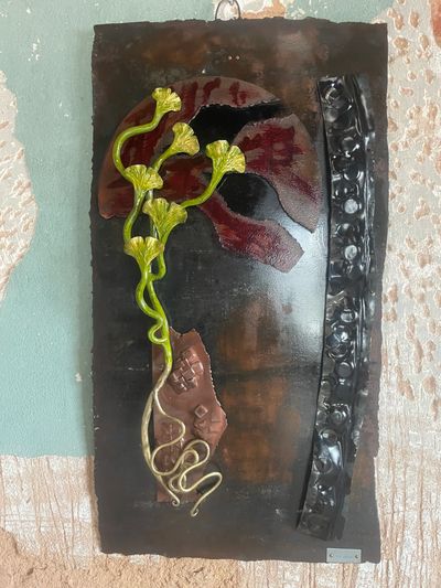 Decorative wall art with leaves and abstract shapes.