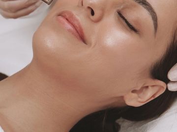 A doctor is treating the patient with microdermabrasion