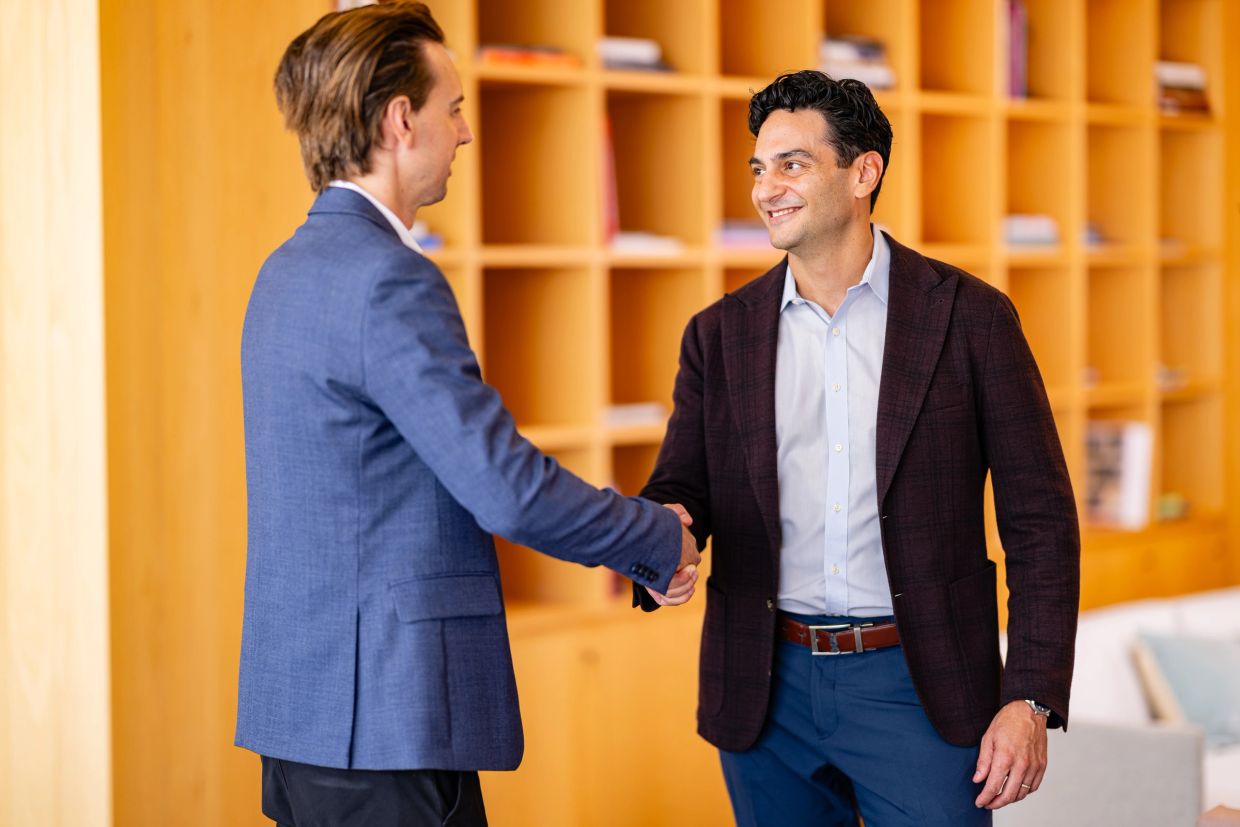 Break Point Energy Managing Director Alex Gupta shaking hands with a client.
