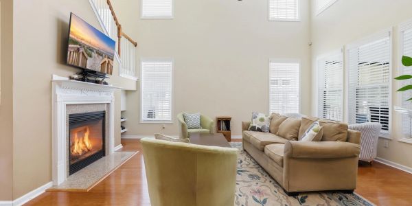 Bright living room with fireplace and beige furniture.
