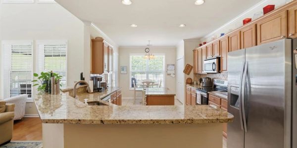 Modern kitchen with granite countertops and stainless steel appliances.