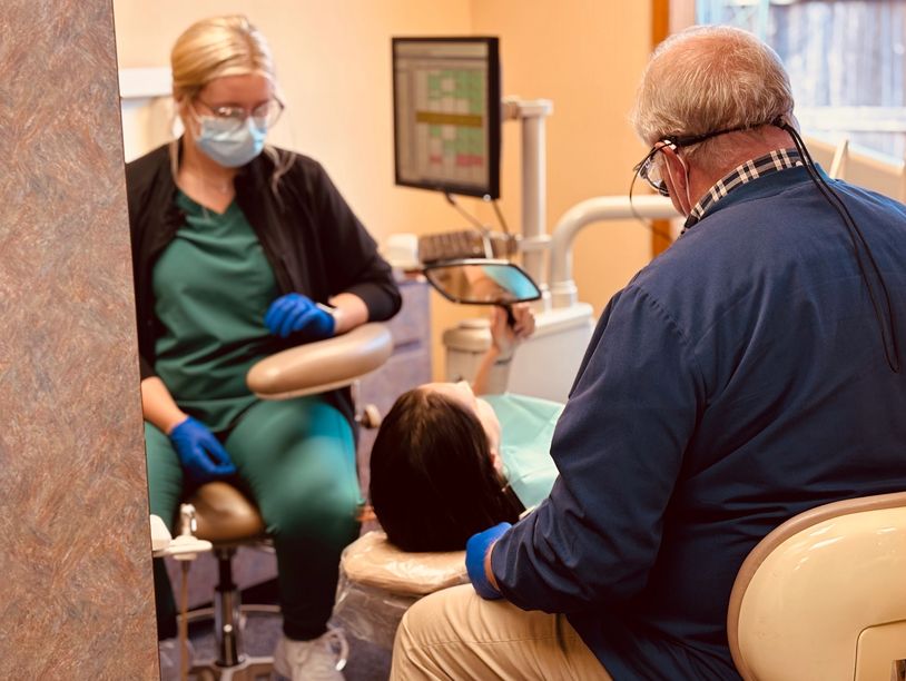 Dentist and chairside assistant working on patient