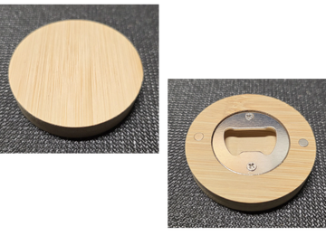 Round bamboo object with a metal bottle opener on one side.