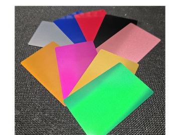 A fan of colorful plastic cards on a textured dark surface.