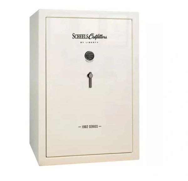 Beige Scheels Outfitters 1902 Series safe with combination lock and key.