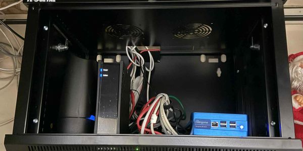 Open server rack with devices and cables inside.