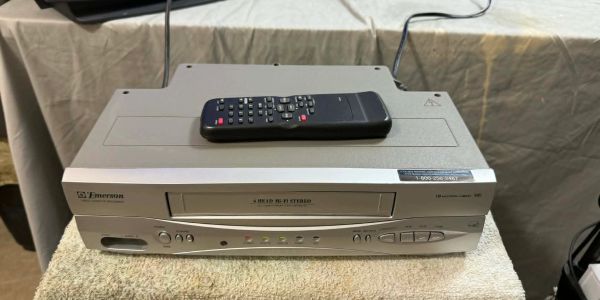 Emerson DVD player with remote on a towel.