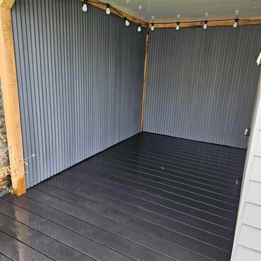 External cladding to form the walls of a pergola and composite decking installation.