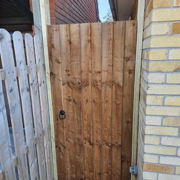 A custom, wooden gate and fence.