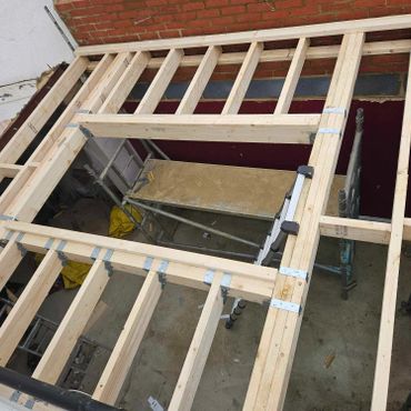Ceiling joists forming the flat roof of an extension.