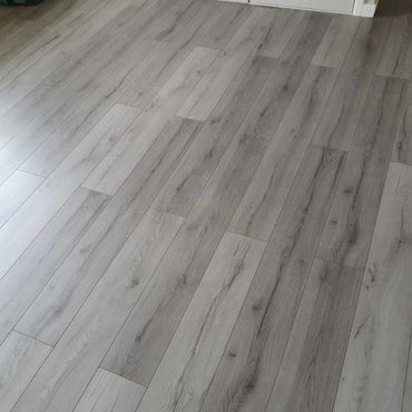 Grey laminate flooring installation.