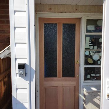 A pine internal door hung with brass ironmongery.
