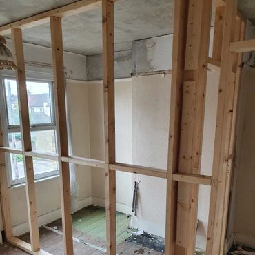 The construction of a partition wall, showing the studwork, for a new ensuite bathroom.