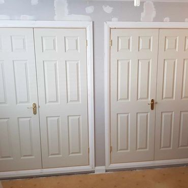 Bespoke wardrobes fitted with internal doors and ironmongery.
