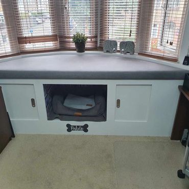 A unit featuring space for a dog bed, which doubles up as a bench with an upholstered seat.