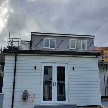 An externally cladded single storey extension.