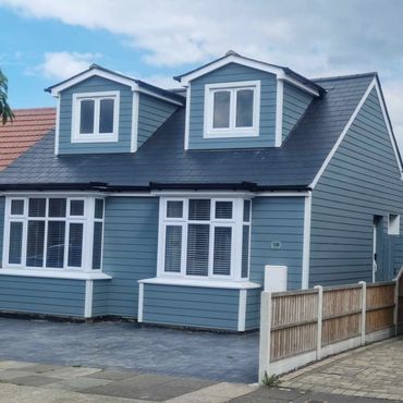 Two pitched dormers on the front of a bungalow, showing the loft conversion, all externally cladded.