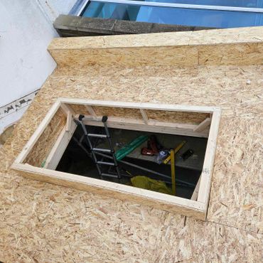 The construction of a flat roof on an extension with opening ready for a lantern.