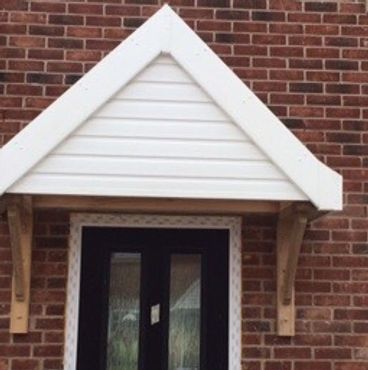 A newly fitted canopy attached to the front of a new build house.