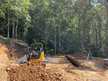 Shane Hamilton and sons Contracting Inc digging footers with an excavator for a home in Green Mounta