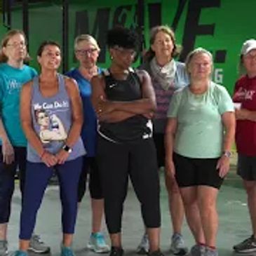 Group of diverse women posing confidently in a gym setting.