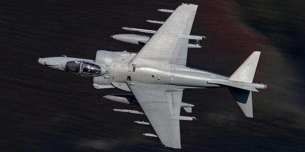 Photo of Harrier jump jet strike fighter flying low level.