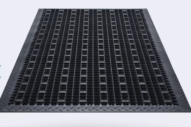 Black anti-fatigue rubber mat with drainage holes and textured border.