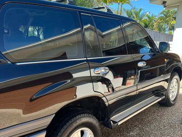 Professional ceramic coating being applied to clean and prepared vehicle paintwork