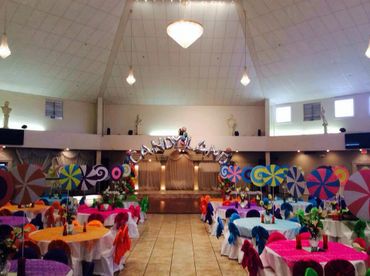 Indoor party setup with colorful candy-themed decorations and balloons.