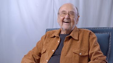 An elderly Storyteller laughs while filming his personal legacy video with The Posterity Project.