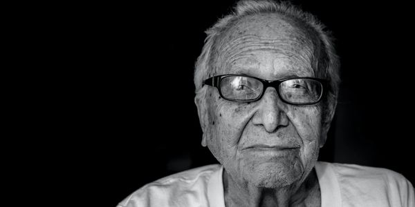 An elderly man poses for his Posterity Project portrait while filming his personal legacy video.
