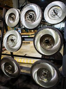 a rack of resurfaced flywheels for exchange at H&H Truck Parts in Cleveland, OH at their commercial truck repair shop