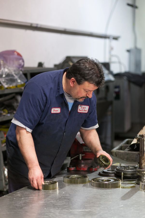 An H&H Truck Parts transmission rebuild technician taking quality control measures to ensure quality